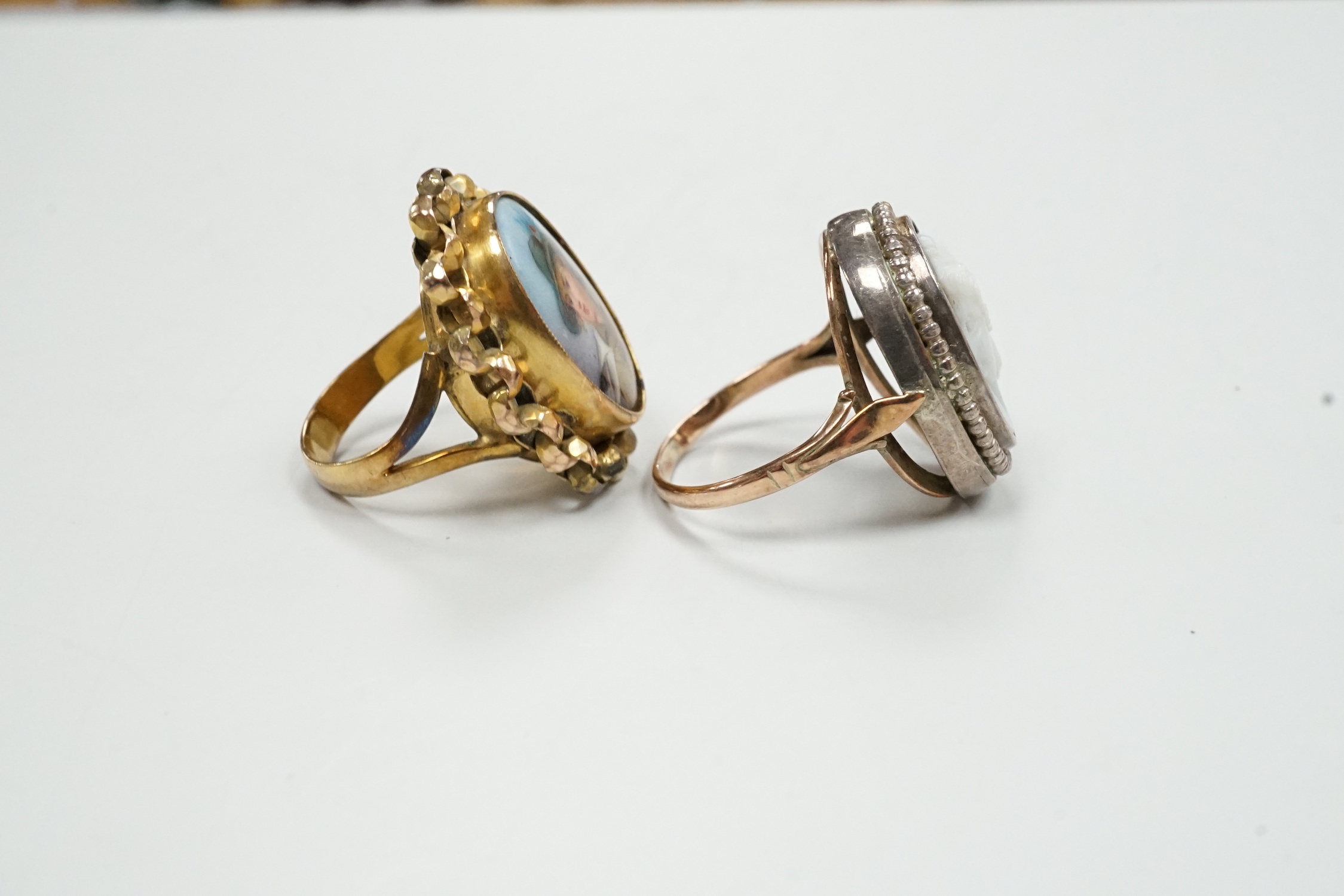 Two yellow metal dress rings, one set with cameo portrait of a lady, the other with porcelain plaque.